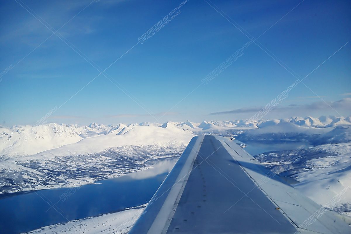 Clouds under the wing of an airplane example image